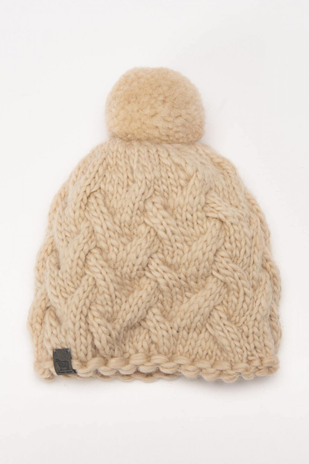 kreminė žieminė vilnonė kepurė